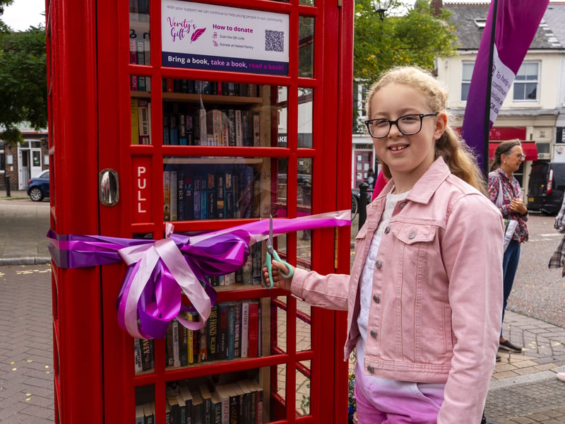 Harriot Turner prepares to cut the ribbon