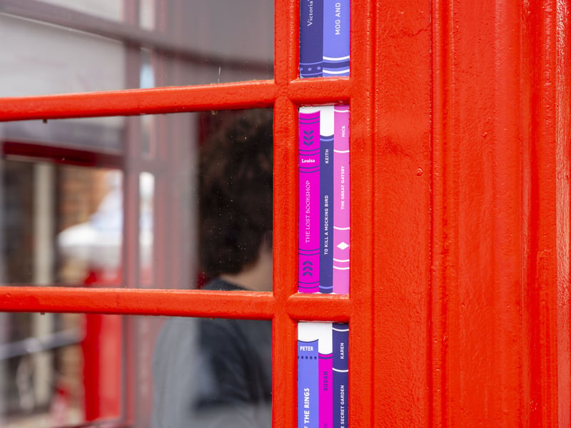 Books have been painted onto the side of the telephone box with some naming key contributors to the poject.