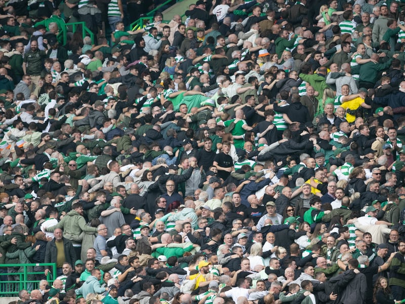 The supporters celebrate Celtic's third goal.