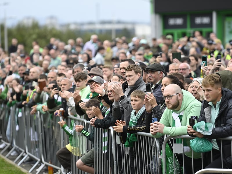 Waiting supporters outside Celtic Park get ready to greet their team.