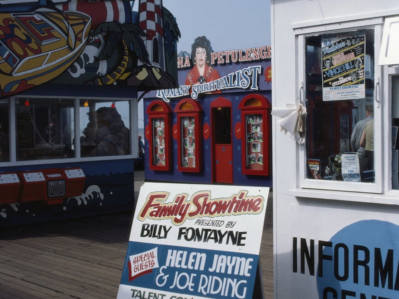 Seaside attractions including a Romany spiritualist and adverts for a family-time talent show with the chance to win ?1500 in the English seaside resort of Blackpool, Lancashire, August 1983