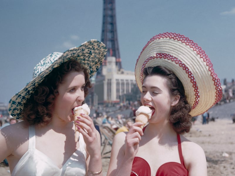 Two girls enjoy ice creams on the sands at Blackpool, July 1954 
