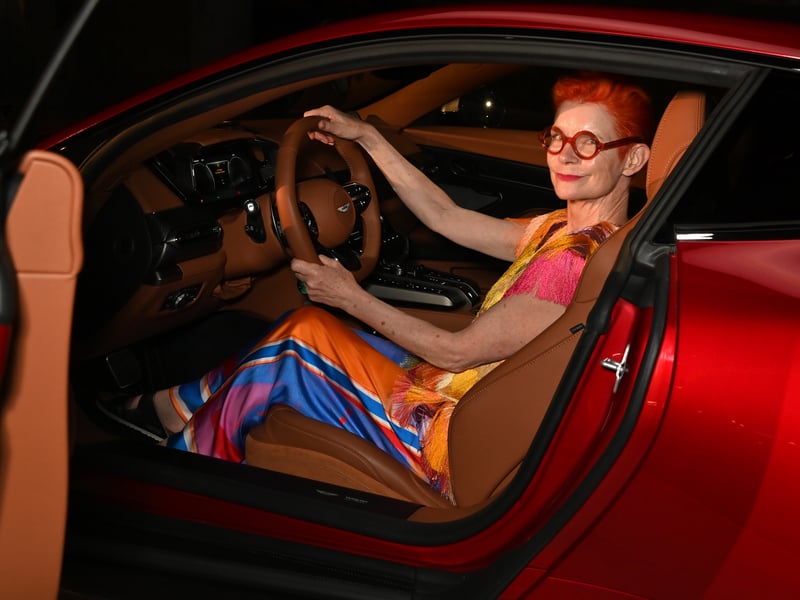 English costume designer Sandy Powel OBE shows off the interior of the Aston Martin in Venice.