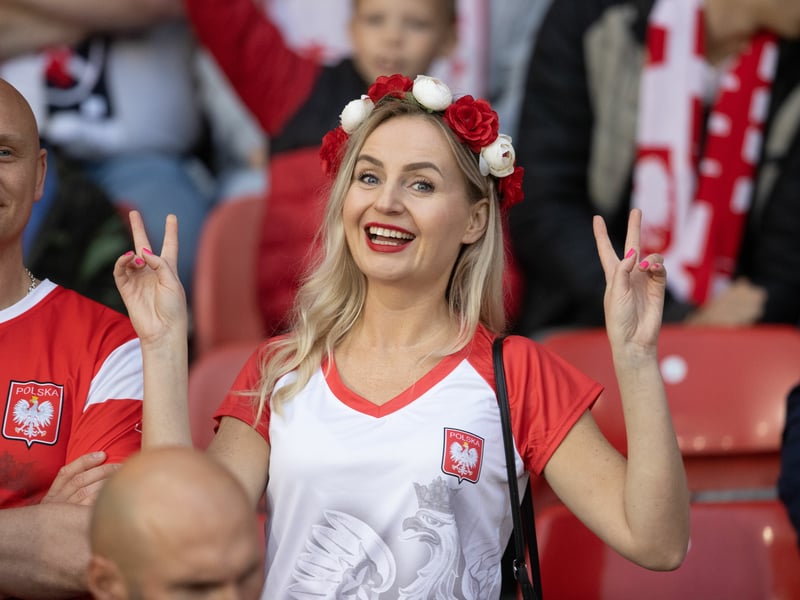 A Poland supporter gives the camera the peace sign ahead of kick off.