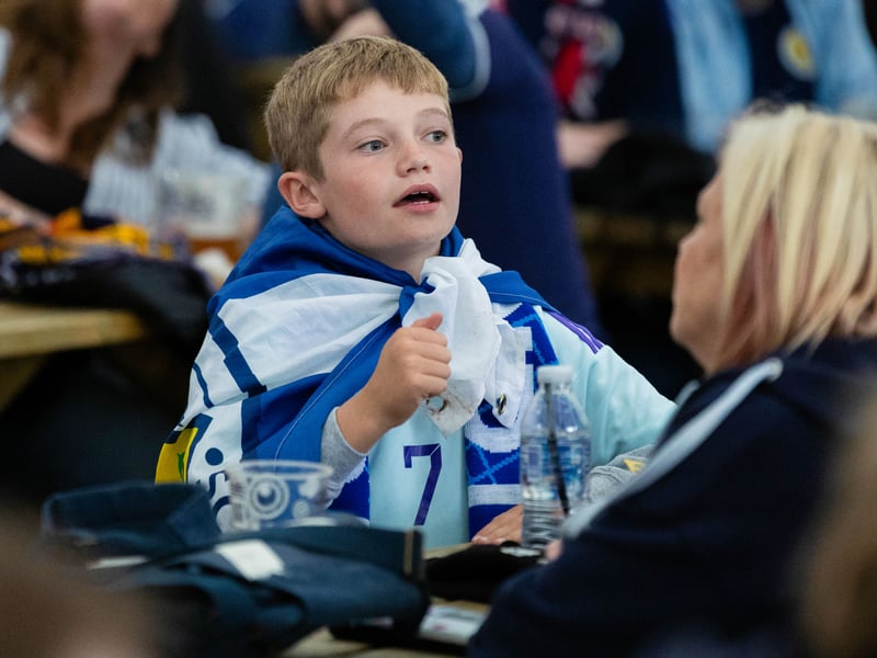 A wee youngster dons the saltire on his back, alongside a number 7 John McGinn away kit.