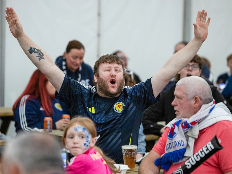 A Scotland supporter enjoys the pre-game atmosphere at the fan zone.