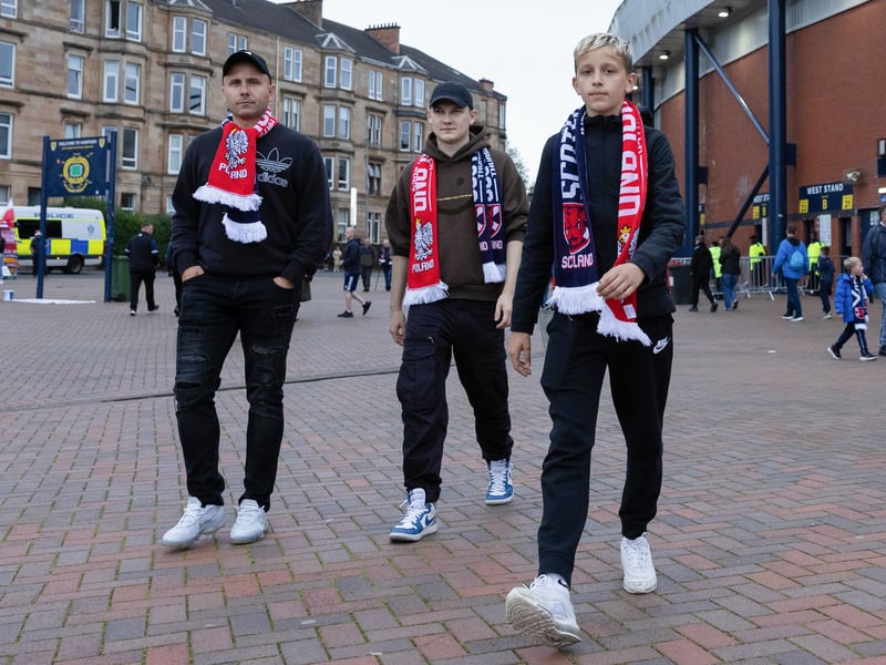 Three supporters with their half and half scarves prepare to enter Hampden.