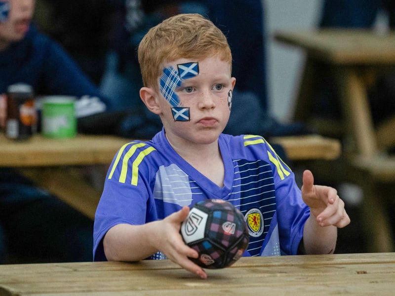 A young Scotland fan with his face painted ahead of the game in the fan zone.