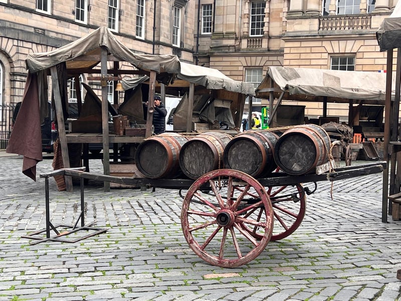 Carts loaded with barrels can be seen on the set