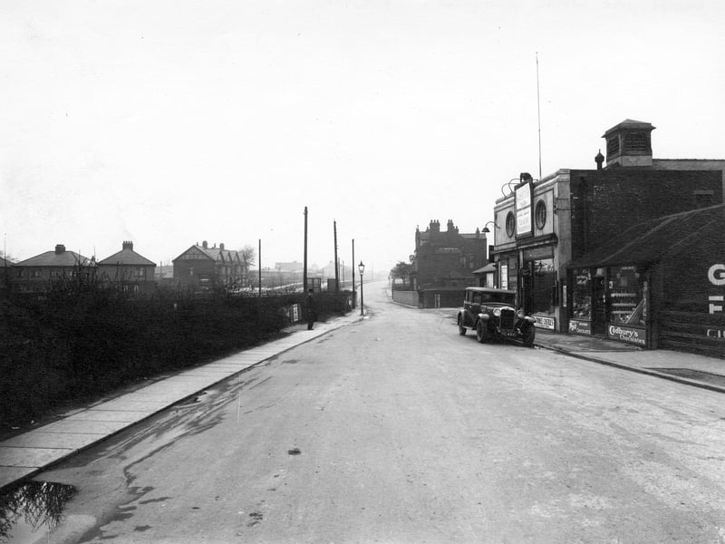 Looking north along Station Road towards the bridge crossing the railway line. On the right is a confectioners then the Crossgates Picture House Cinema, which opened on 5th August 1920 and closed 16th May 1965. Next to this is the entrance to the railway station and beyond the bridge the Station Hotel. On the far left are houses on Cold Well Road.