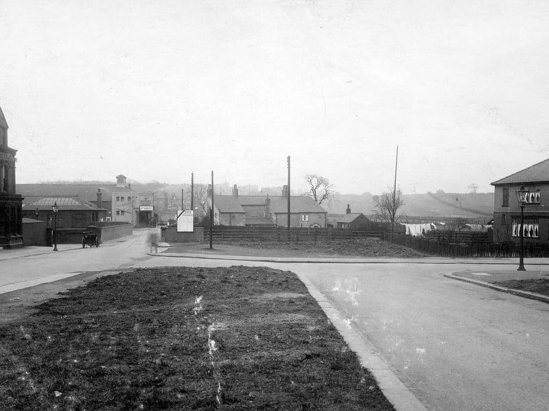 View down Station Road towards bridge over L N E R with Cold Well Road on the right (now Coldwell Road). Before the bridge, on the left is The Station Hotel. Pictured in March 1931.