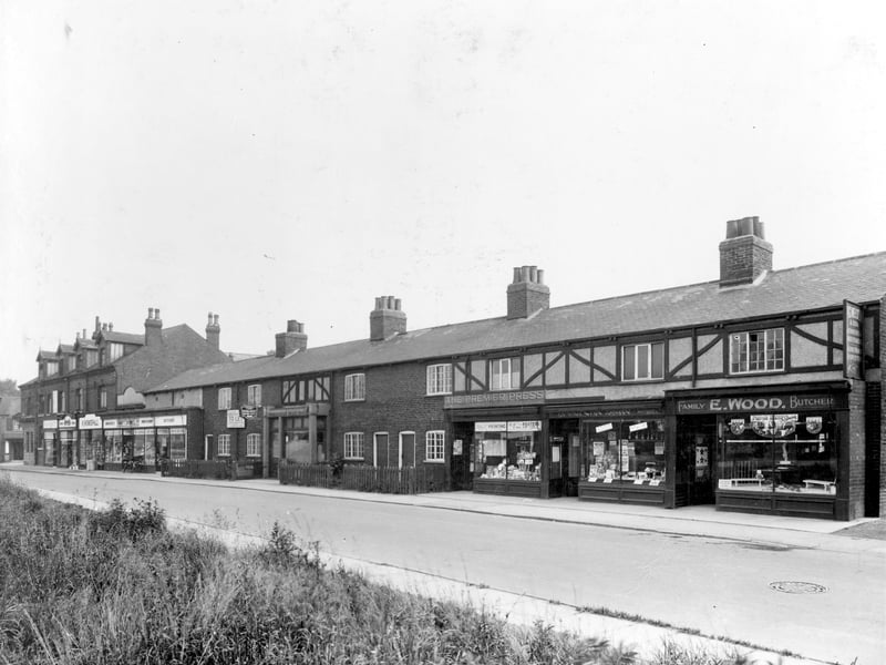 Station Road in August 1937. On the left is the junction with Austhorpe Road. Then number 69 is a branch of the National Provincial Bank. Moving right, ending with the Thrift Stores are shops numbered 67 to 61a. In the centre at number 53 is a branch of the Leeds Permanent Building Society. Again moving right, number 47 is a printers, The Premier Printing Press. Next at number 45 L. Swales has Ye Olde Tripe Shoppe, notice in the window boasts 'Tripe is good for you!'. Edward Wood has the butchers shop at number 43.