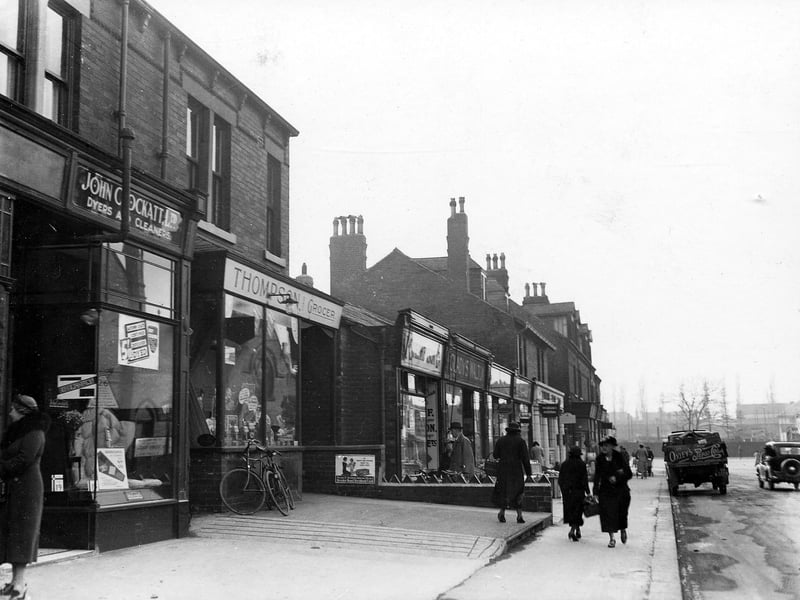Shops on Austhorpe Road in October 1938.. In focus are John Crockatt, dyers and cleaners number 16, William Taylor Thompson, grocers at number 14, Isaac Stephenson, butcher at number 12D, Gladys Walton, greengrocer number 12C, Meadow Dairy number 12B and Taylors Chemist at number 12A. 