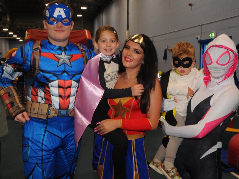 Pictured are Darcy Papadakis, eight, and brother Xander, two, with Captain America, Wonder Woman and Ghost Spider