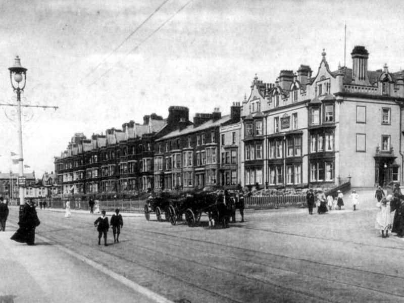 The promenade has never looked as sedate as in this early view of Imperial Crescent with landaus instead of cars and young boys strolling along the open road . The crescent remains recognisable today, with the hotels sporting bright rendering , modernised ground floor fascades and off-street parking.. The road to the right leads to the junction of Dickson Road and Pleasant Street and just visible at the end of the crescent is the Palm Court Restaurant and the "turret" roof of the Imperial Hotel can just be seen