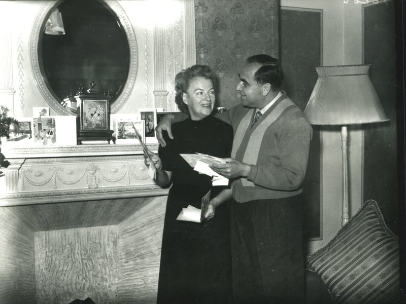 Gracie Fields and her husband Boris Alperovici looking at their Christmas cards in their suite at the Imperial Hotel, Blackpool on Christmas Eve 1955