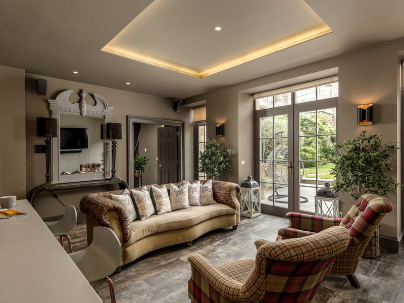 The property has living and reception space on the ground, first and lower ground floors. This room has French doors leading to a suntrap patio.