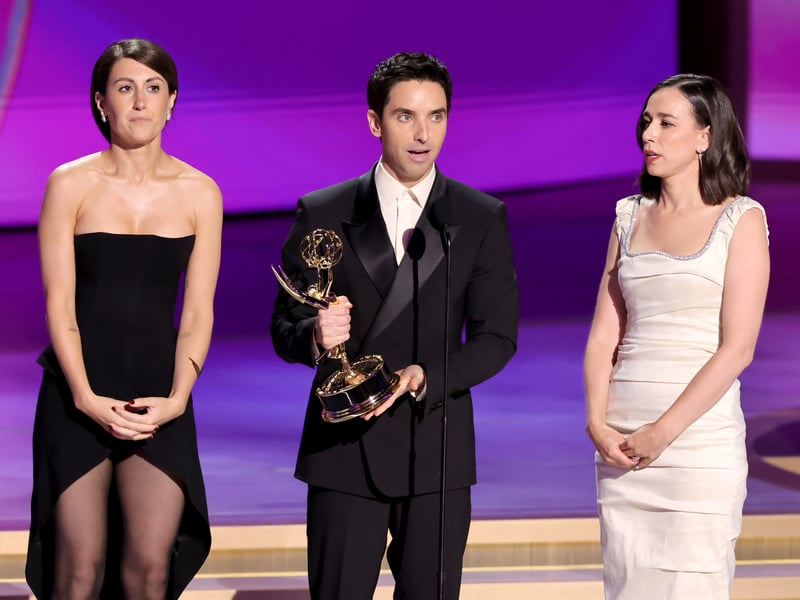 Jen Statsky, Paul W. Downs, and Lucia Aniello accept the Outstanding Writing for a Comedy Series award for Hacks onstage during the 76th Primetime Emmy Awards.