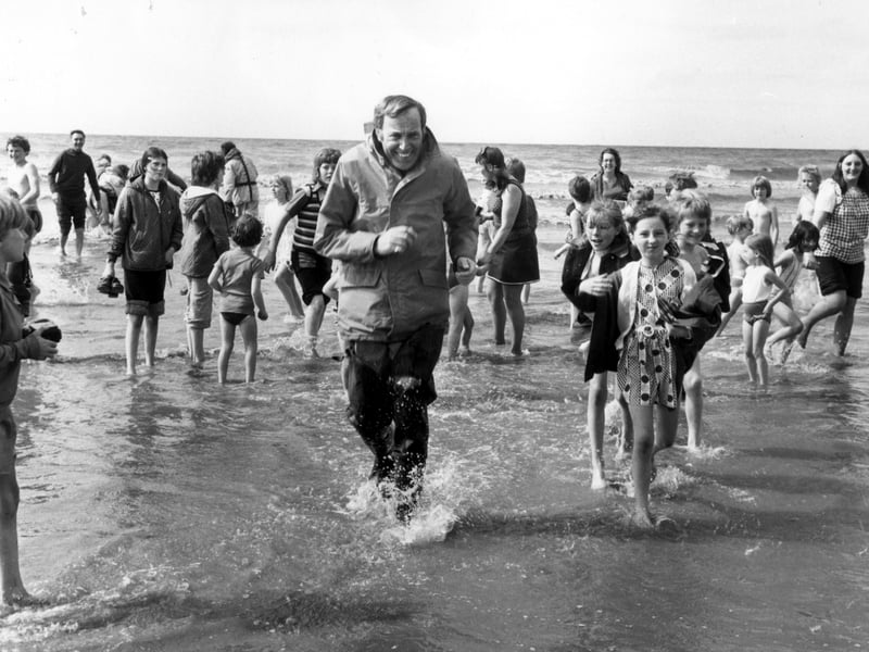 Irish crooner Val Doonican wades ashore on Blackpool Beach in 1974 - no doubt back to the comfort of his famous rocking chair