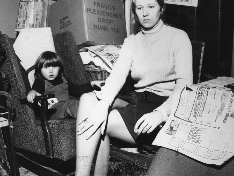 Mrs Sandra Carter, a civil servant, with Kristian, among her packed boxes of belongings. Photo is titled Ibbison Street 'slums' November 1974