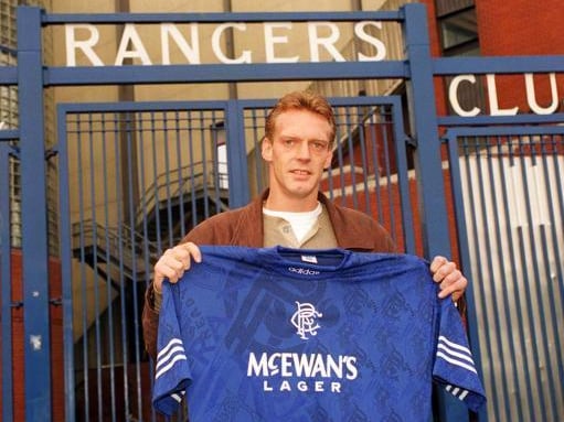 Dutch forward Peter Van Vossen holds up his new playing colours outside of Ibrox in 1996.