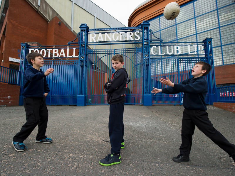 Three young Rangers fans outside of the gates in 2012.
