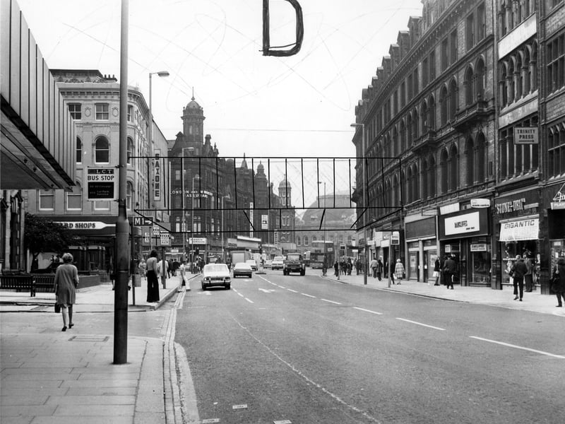 Looking east along Boar Lane, taken in the mid 1970s. On the left is C & A, then hidden from view Holy Trinity Church, followed by Richard Shops ladieswear. Further along is the junction with Briggate. Shops on the right include Finlay's tobacconist (partly visible on the far right), Stone-Dri weatherwear, at number 12, and temporary premises of Rawcliffe's clothiers whose store on Duncan Street is undergoing renovation; this is just visible in the distance.