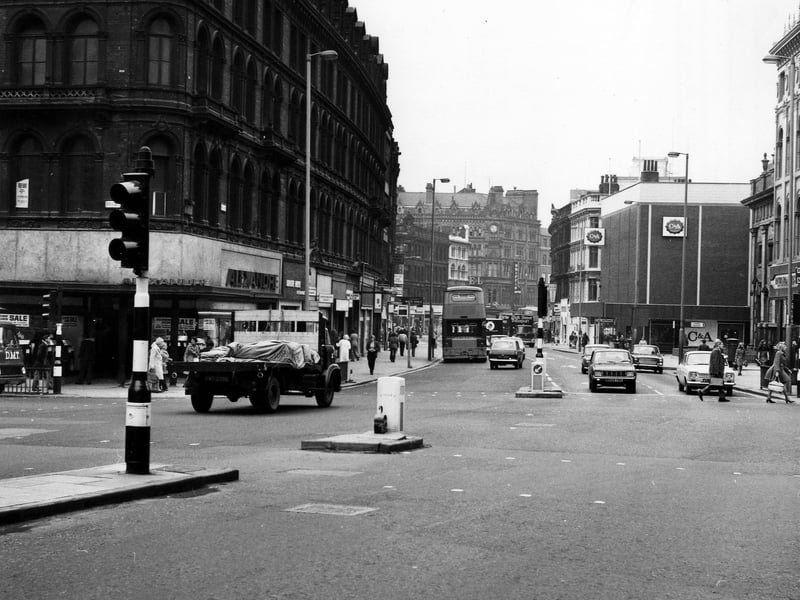 Boar Lane looking west, seen from Duncan Street with the junction with Briggate on the left. Alexandre menswear is on the corner, with the White Rose Restaurant next to this. On the right are Richard Shops ladieswear and C & A, with Holy Trinity Church out of view in between. Taken during the mid 1970s.