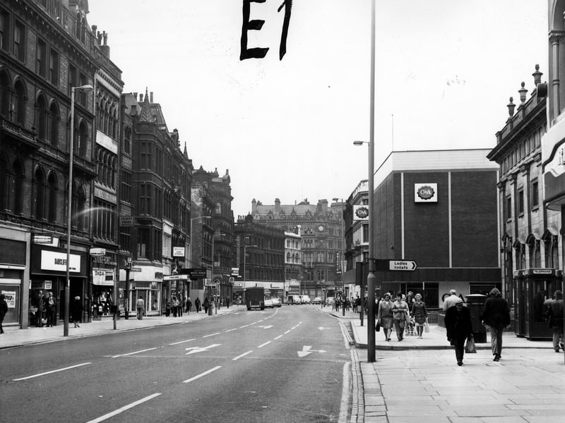 Boar Lane looking west, taken during the mid 1970s. Shops on the left include Rawcliffe's clothiers (temporary premises while their Duncan Street store is being renovated), Stone-Dri weather wear and Finlay's tobacconists, then after the junction with White Horse Street, the Singer Sewing Machine Co. Ltd., Finigan's ladieswear, Wakefields Army Stores and the White Horse Resturant. On the right are Holy Trinity Church, with two telephone kiosks and a postbox in front, and C & A.