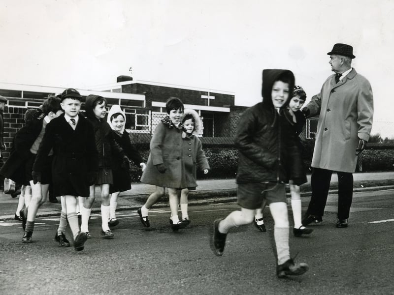 Headmaster Mr F A Albrighton sees the schoolchildren safely across Bispham Road after the school was left without a lollipop man because of illness