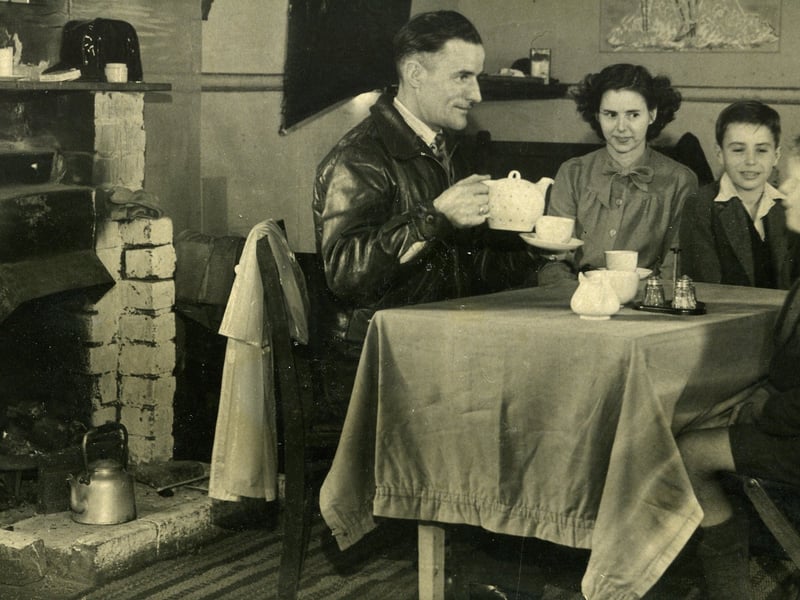 Squatters move into wooden huts off St Annes Road, Blackpool which were built for the army during World War Two . They had previously been living in overcrowded conditions with relatives or in rented accommodation.
Here one family is enjoying their first pot of tea in their new home, 1946