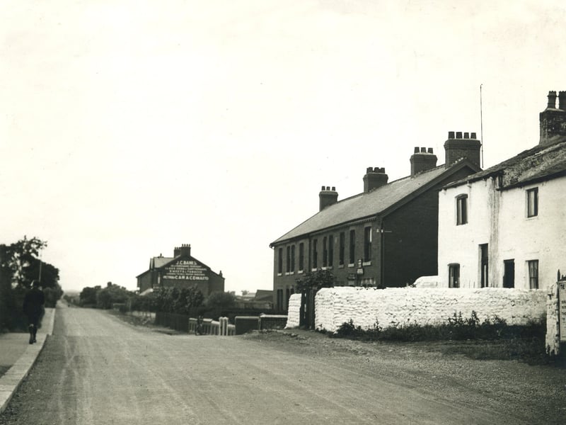 School Road, Marton Moss Village. The hardware store and Tuck Shop in the distance was run by the Banks family from 1919, when it was a general store and filling station, until 1980 when 79 year old widower Arthur Banks was murdered . He was known to the children of nearby St Nicholas School as Uncle Arthur. The Marton Moss Sub Post Office and grocery store which closed in the 1950s is also visible next to the white washed cottage which has since been demolished. The terrace of houses is known as Pleasant View.