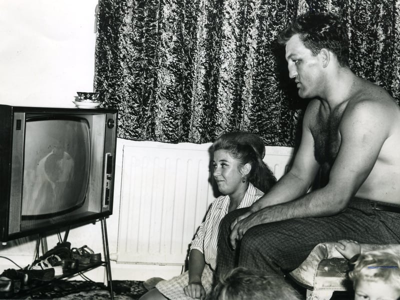 Brian London v Cassius Clay fight. Relaxing at home, Brian London sits with his wife Veronica to watch the telerecording of his fight with Cassius Clay
