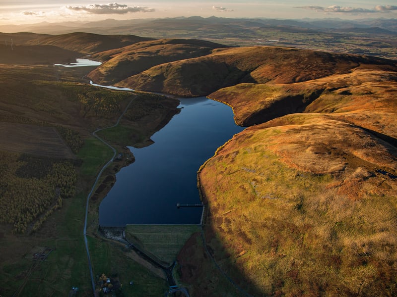 The manmade reservoir is hugged by the Ochil Hills.