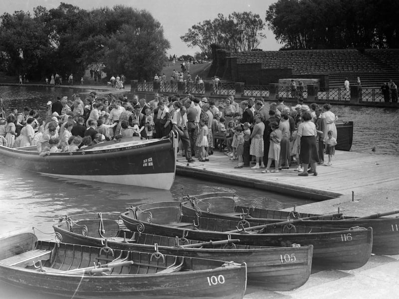 Bank Holiday crowds queue for a boat trip around Stanley Park lake on the former lifeboat The Samuel Fletche