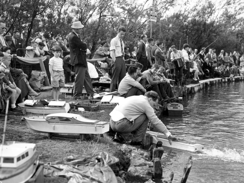 Spectators and competitors at the radio-controlled model boats regatta held at Stanley Park lake, 1961