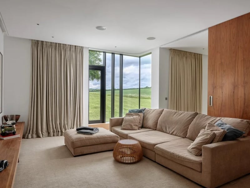 The listing says: "Sitting in a tranquil valley in about 2.5 acres of gardens and grounds (including a wildflower meadow), the house offers a master bedroom suite with dressing rooms and 4 further bedrooms all with ensuite bathrooms. "