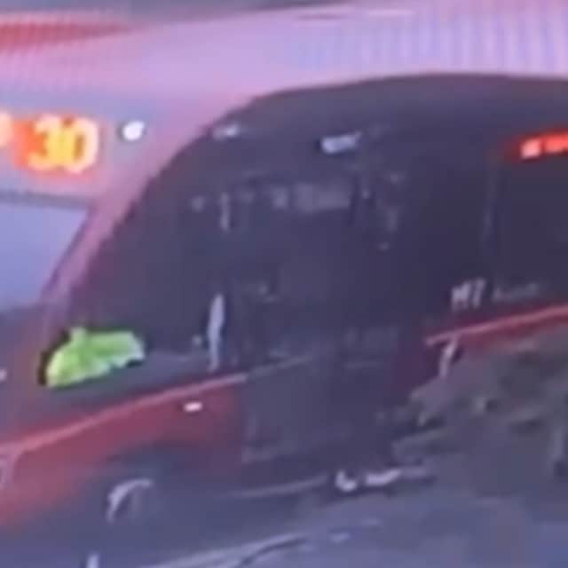 CCTV shows Zoe at the base of the doors, stuck, with the bus driving away,
