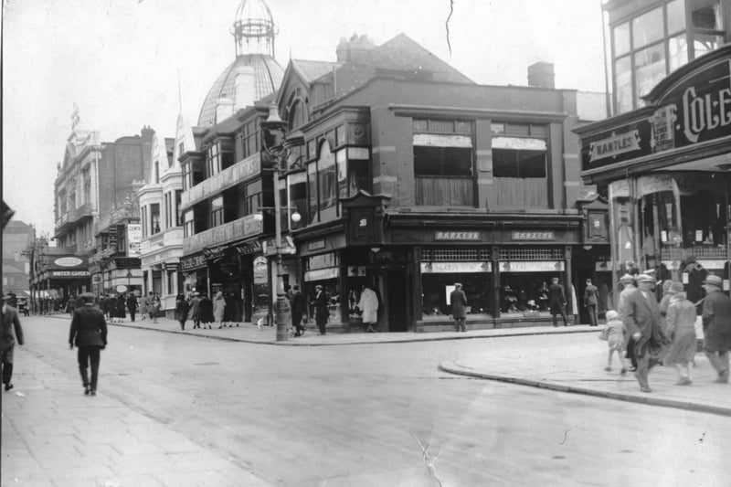 Church street junction of Coronation Street 1930s. The shop right of centre is Barkers and is advertising ' holiday Wear ' at the top of it's windows. It was replaced in 1938 by Littlewoods and the White building is the Adelphi Hotel. To the right of the hotel is Taylors Chemist - note canopy at the entrance to the Winter Gardens and the original top of the dome