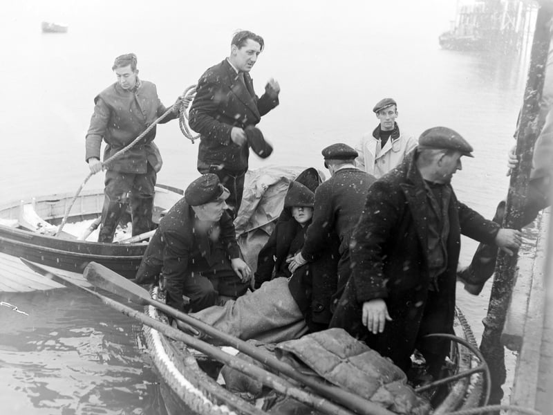 Three Blackpool youths were rescued, near the mouth of the River Ribble, by Lytham Lifeboat, after spending the night in a rubber dingy. The three, who were taken to hospital, were named as Richard Walsh (16), James Varey (18) and Bobby Waddington (17). Picture shows the boys huddled together as they were brought ashore at Lytham
