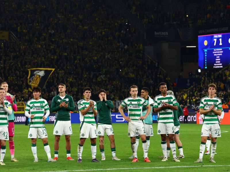 Dejected Celtic players acknowledge the travelling away support.