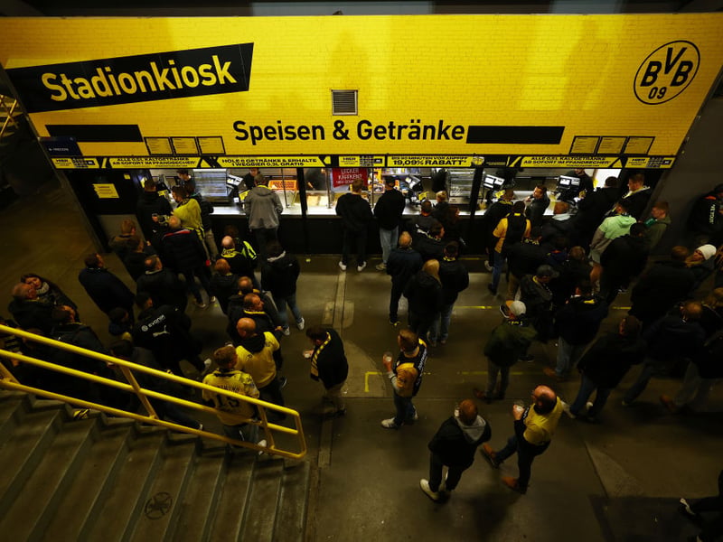 Dortmund fans prepare for the visit of Celtic by grabbing some food and drink before the game.