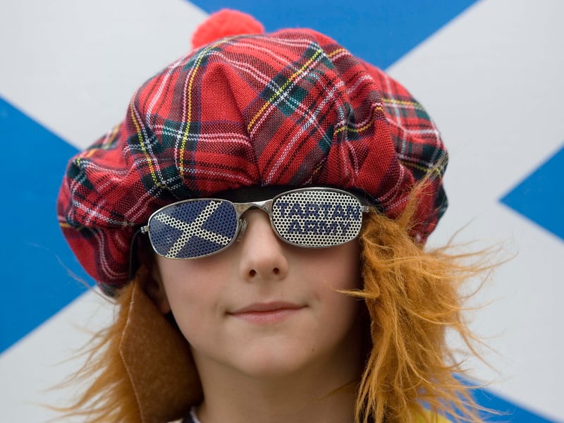 A young Scotland fan supports his team in style.