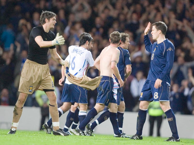 Craig Gordon (left) celebrates with Scotland goal scorer Gary Caldwell after victory over France.