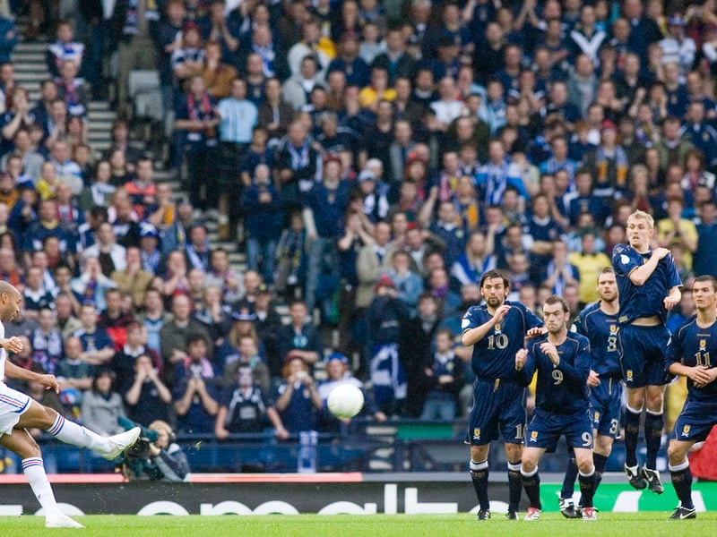 Thierry Henry (left) fires an impressive free kick over the Scotland wall and off the post.
