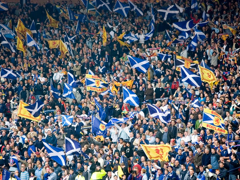 Scotland supporters fly flags in celebration of a famous victory at Hampden against France.