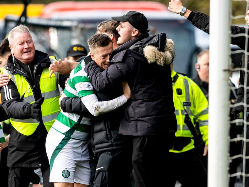 Captain Callum McGregor celebrates the winning goal with a fan.
