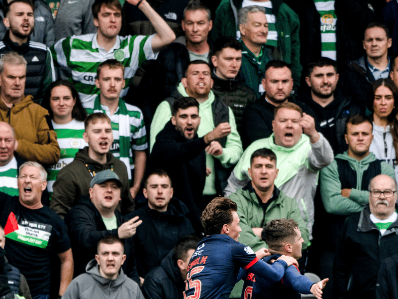 Celtic supporters show their unhappiness at the team conceding the opening goal as Ronan Hale celebrates.