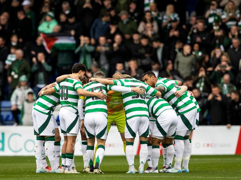 Celtic players huddle as fans watch on at Dingwall.