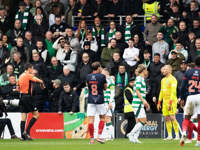 Travelling Celtic fans show their frustration after referee Kevin Clancy orders a re-take of Ross County's penalty.